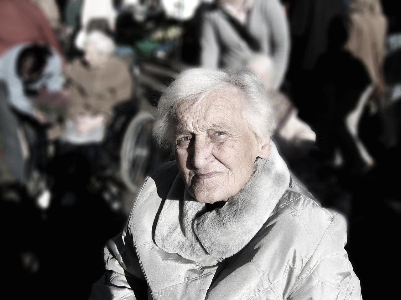Aged care staff calming a resident experiencing sundowning in low evening light